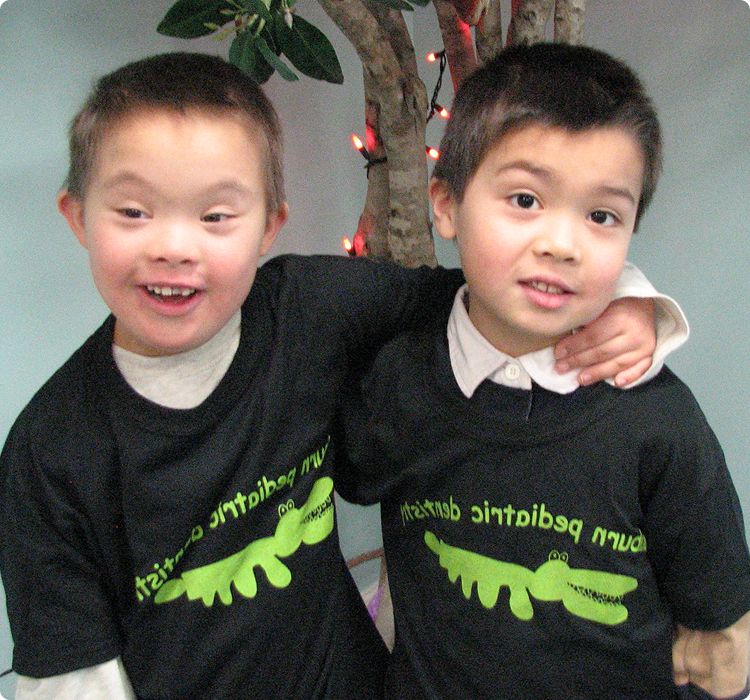 About page content image 2 Two young boys with arms over each others' shoulder